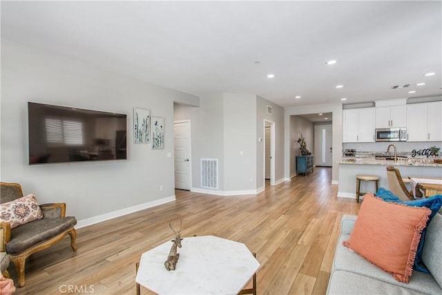 1563 Sunswept Way, Beaumont, CA 92223 - living area with recessed lighting and light wood-style floors