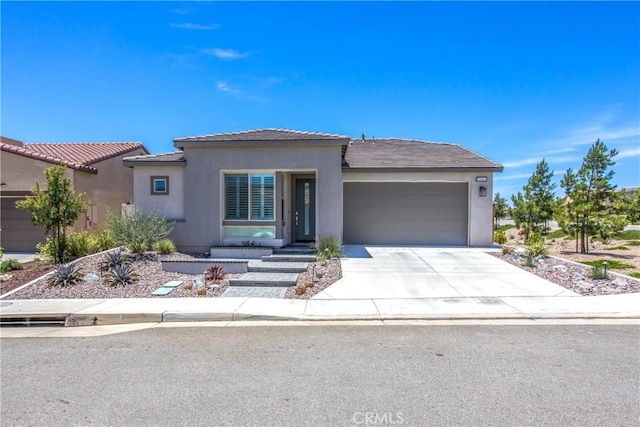 1563 Sunswept Way, Beaumont, CA 92223 - view of front of property with an attached garage, stucco siding, driveway, and a tile roof