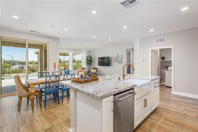 1563 Sunswept Way, Beaumont, CA 92223 - kitchen with stainless steel dishwasher, white cabinets, light wood-type flooring, recessed lighting, and light stone countertops