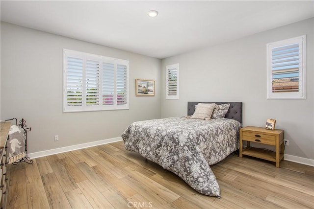 1563 Sunswept Way, Beaumont, CA 92223 - bedroom with multiple windows, light wood-style flooring, and recessed lighting