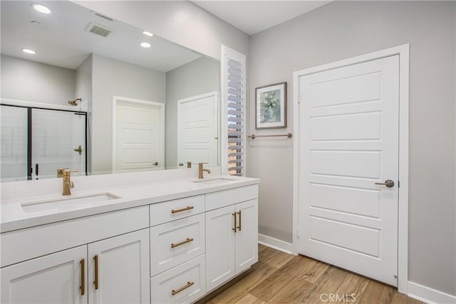 1563 Sunswept Way, Beaumont, CA 92223 - full bathroom featuring double vanity, wood finished floors, a shower stall, and recessed lighting