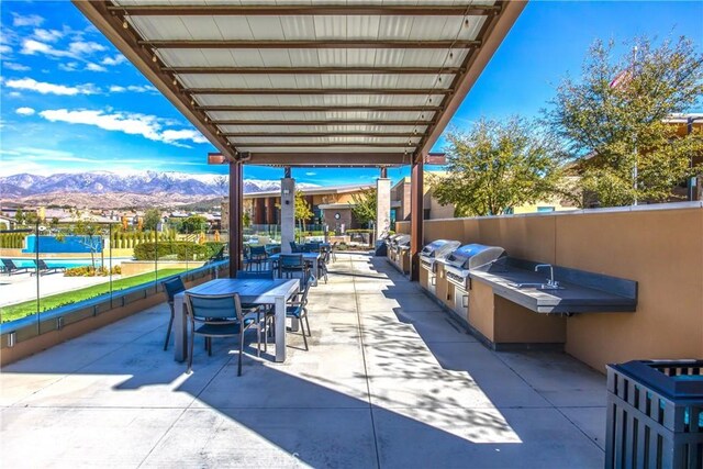 1563 Sunswept Way, Beaumont, CA 92223 - view of patio / terrace with an outdoor kitchen, a mountain view, and outdoor dining area
