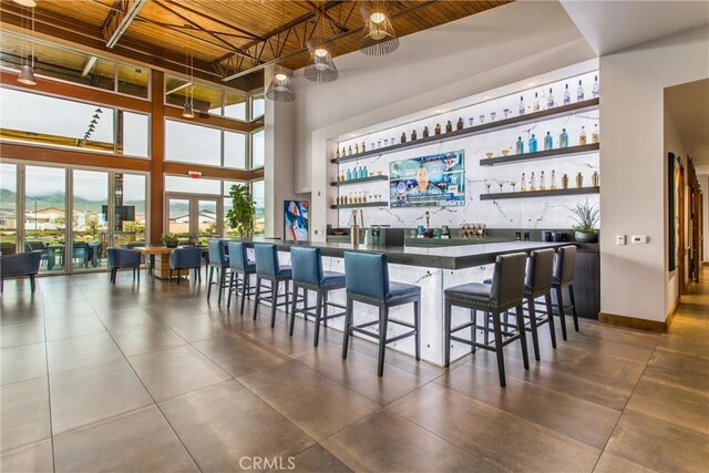 1563 Sunswept Way, Beaumont, CA 92223 - indoor wet bar with a high ceiling, dark tile patterned floors, and wood ceiling