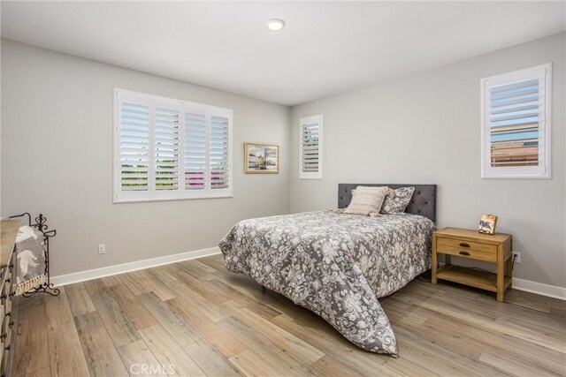 1563 Sunswept Way, Beaumont, CA 92223 - bedroom featuring multiple windows, light wood-type flooring, and recessed lighting