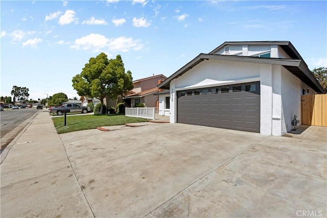 13635 Frady Ave, Chino, CA 91710 - view of home's exterior with driveway, stucco siding, and a garage