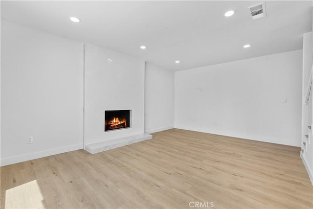 13635 Frady Ave, Chino, CA 91710 - unfurnished living room featuring a premium fireplace, recessed lighting, and light wood-style floors