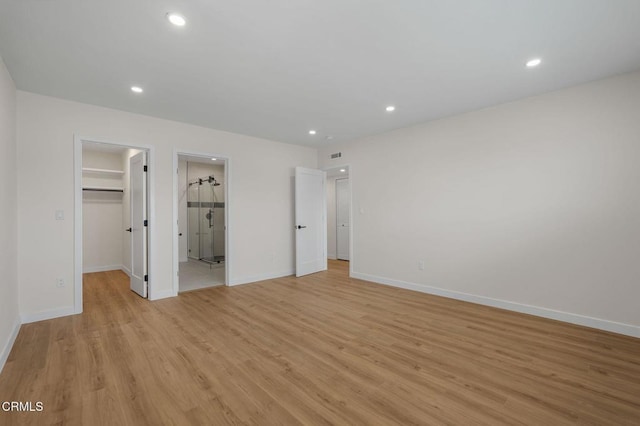 1200 W Huntington Dr Unit 21, Arcadia, CA 91007 - unfurnished bedroom featuring a spacious closet, light wood-style flooring, recessed lighting, a closet, and ensuite bathroom
