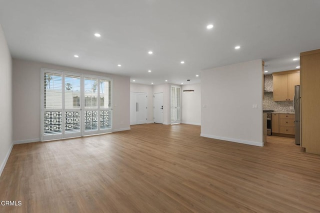 1200 W Huntington Dr Unit 21, Arcadia, CA 91007 - unfurnished living room featuring light wood-style flooring and recessed lighting