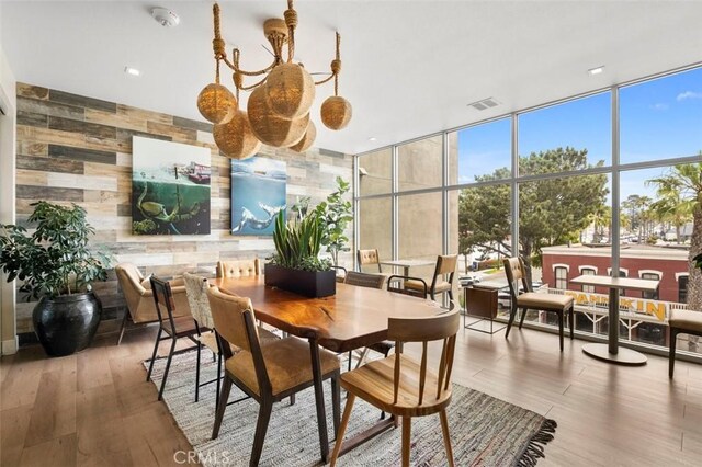 355 N Cleveland St Unit 211, Oceanside, CA 92054 - dining space featuring expansive windows, wood finished floors, and wooden walls