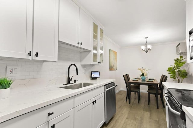 9959 Azuaga St Unit 105, San Diego, CA 92129 - kitchen with appliances with stainless steel finishes, decorative backsplash, white cabinets, light wood-type flooring, and a chandelier