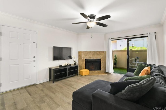 9959 Azuaga St Unit 105, San Diego, CA 92129 - living area featuring crown molding, ceiling fan, wood finished floors, and a fireplace