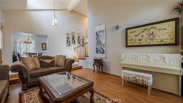 25961 Brookmere Ave, Loma Linda, CA 92354 - living area featuring a chandelier, high vaulted ceiling, stairs, wood finished floors, and beam ceiling