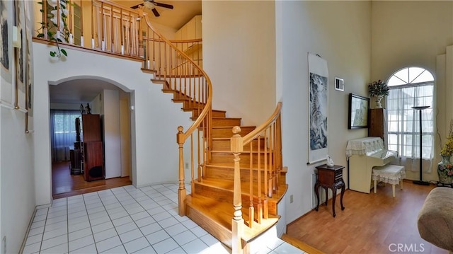 25961 Brookmere Ave, Loma Linda, CA 92354 - foyer featuring a high ceiling, arched walkways, a ceiling fan, stairway, and light tile patterned floors