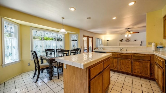 25961 Brookmere Ave, Loma Linda, CA 92354 - kitchen with tile counters, healthy amount of natural light, brown cabinets, light tile patterned flooring, and recessed lighting