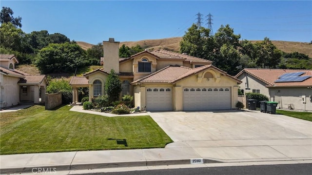 25961 Brookmere Ave, Loma Linda, CA 92354 - mediterranean / spanish home with a garage, stucco siding, concrete driveway, and a chimney