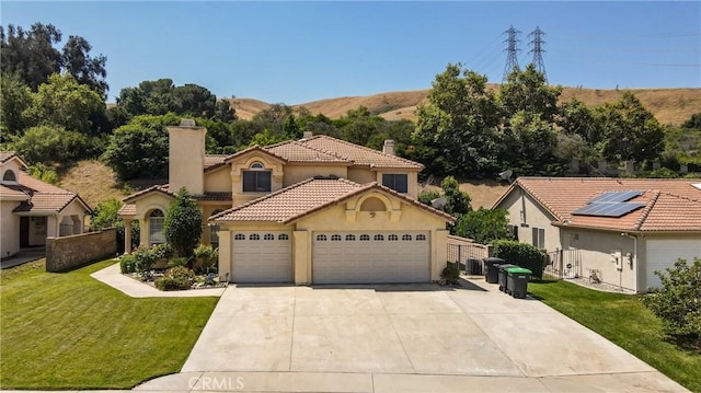 25961 Brookmere Ave, Loma Linda, CA 92354 - mediterranean / spanish-style home featuring a chimney, stucco siding, a garage, and driveway
