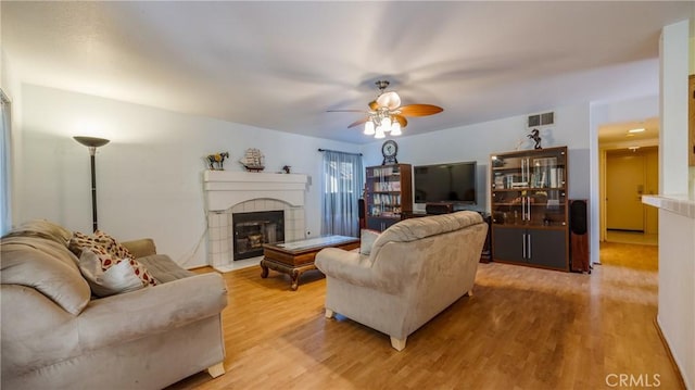 25961 Brookmere Ave, Loma Linda, CA 92354 - living area with a ceiling fan, light wood-type flooring, and a fireplace with flush hearth