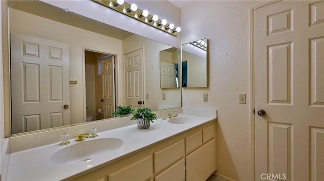 25961 Brookmere Ave, Loma Linda, CA 92354 - bathroom featuring double vanity and toilet