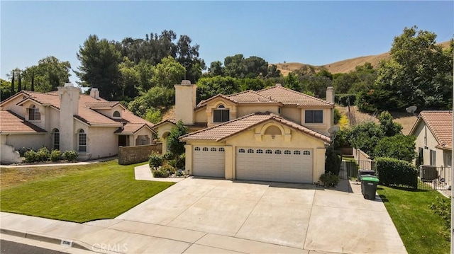 25961 Brookmere Ave, Loma Linda, CA 92354 - mediterranean / spanish house with a chimney, a garage, concrete driveway, stucco siding, and a tiled roof