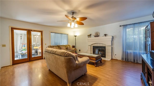 25961 Brookmere Ave, Loma Linda, CA 92354 - living area featuring french doors, wood finished floors, a ceiling fan, and a tile fireplace