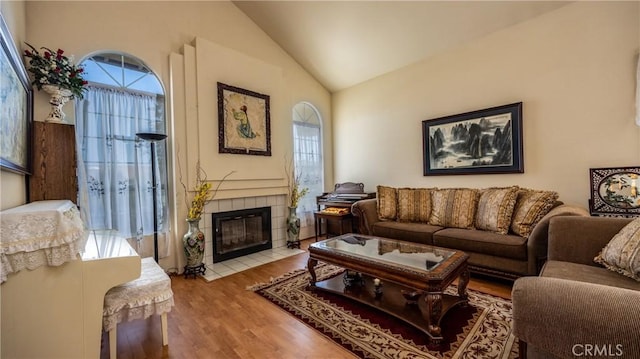 25961 Brookmere Ave, Loma Linda, CA 92354 - living room featuring plenty of natural light, wood finished floors, a tiled fireplace, and high vaulted ceiling