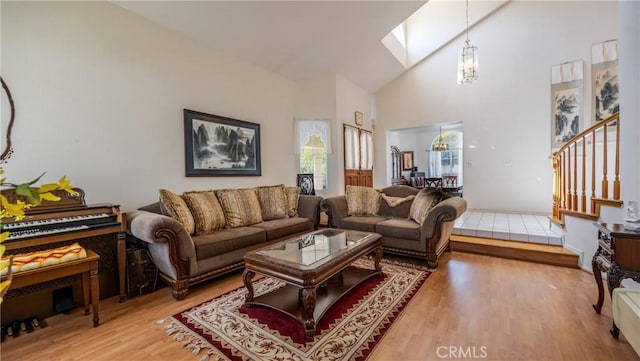 25961 Brookmere Ave, Loma Linda, CA 92354 - living area with wood finished floors, a skylight, high vaulted ceiling, stairs, and a chandelier