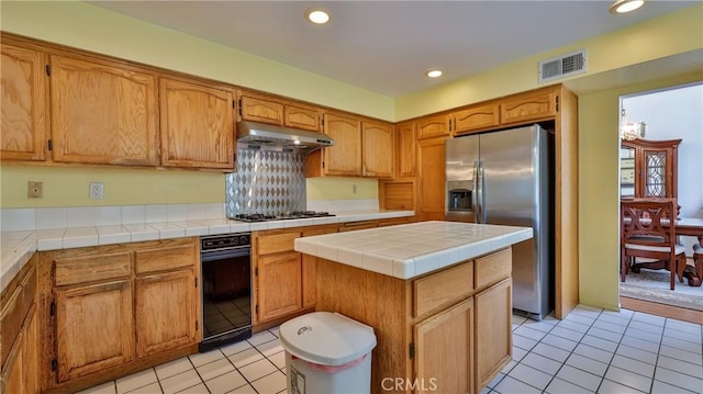 25961 Brookmere Ave, Loma Linda, CA 92354 - kitchen featuring appliances with stainless steel finishes, under cabinet range hood, light tile patterned floors, recessed lighting, and a center island