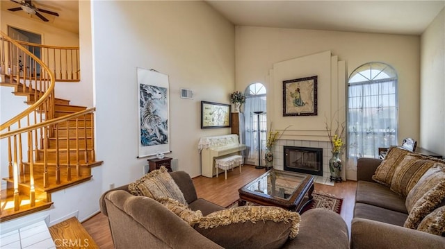 25961 Brookmere Ave, Loma Linda, CA 92354 - living area with stairs, a tile fireplace, wood finished floors, high vaulted ceiling, and ceiling fan