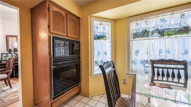 25961 Brookmere Ave, Loma Linda, CA 92354 - kitchen featuring black appliances, plenty of natural light, brown cabinetry, and light tile patterned flooring