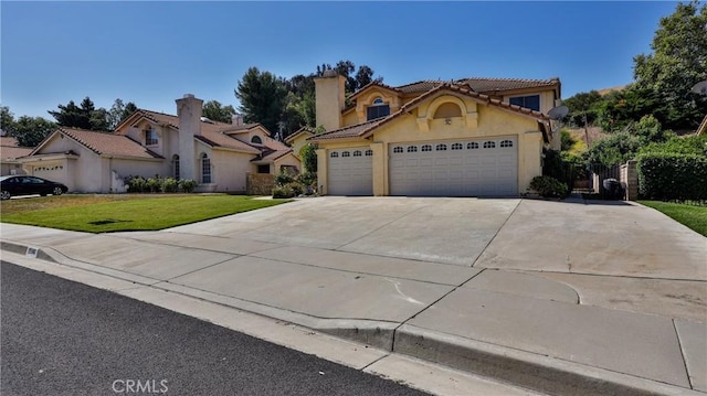 25961 Brookmere Ave, Loma Linda, CA 92354 - mediterranean / spanish-style home featuring concrete driveway, a front yard, an attached garage, stucco siding, and a tile roof