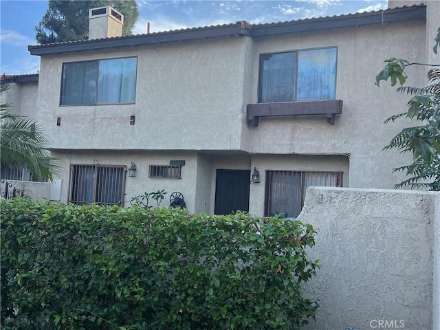 13500 Ramona Pkwy, Baldwin Park, CA 91706 - view of front of house featuring stucco siding and a chimney