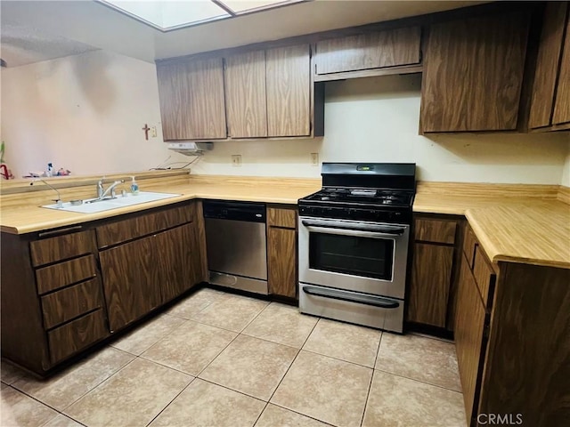 13500 Ramona Pkwy, Baldwin Park, CA 91706 - kitchen featuring appliances with stainless steel finishes, a peninsula, light tile patterned floors, and light countertops
