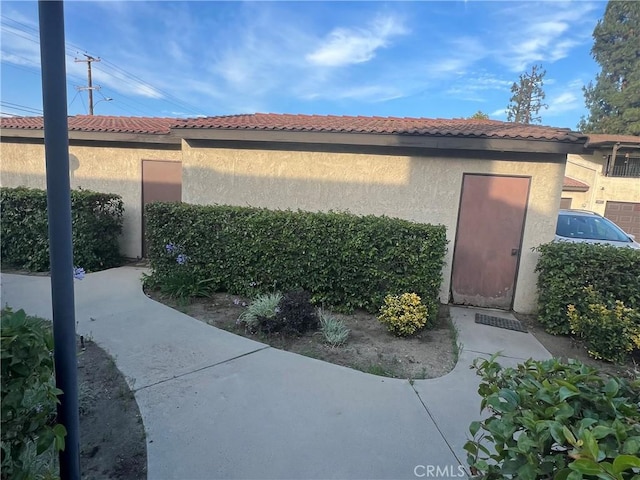 13500 Ramona Pkwy, Baldwin Park, CA 91706 - view of property exterior with stucco siding and a tiled roof