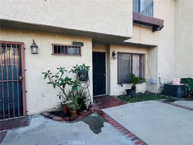 13500 Ramona Pkwy, Baldwin Park, CA 91706 - view of exterior entry with stucco siding and a patio