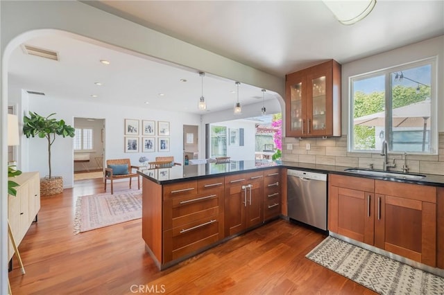 7838 Stewart Ave, Los Angeles, CA 90045 - kitchen featuring stainless steel dishwasher, wood finished floors, brown cabinetry, plenty of natural light, and recessed lighting