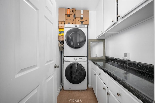 1879 Atlantic Ave Unit 15, Long Beach, CA 90806 - washroom with stacked washer and clothes dryer, light tile patterned flooring, and cabinet space
