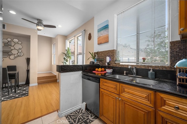 1879 Atlantic Ave Unit 15, Long Beach, CA 90806 - kitchen with stainless steel dishwasher, brown cabinets, backsplash, ceiling fan, and light wood-style floors