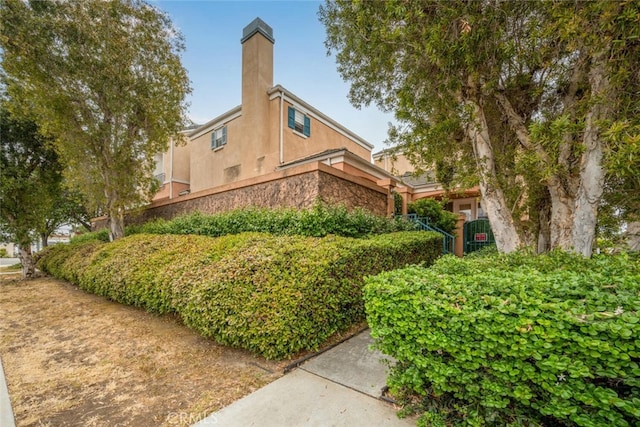 1879 Atlantic Ave Unit 15, Long Beach, CA 90806 - view of side of property featuring stucco siding and a chimney