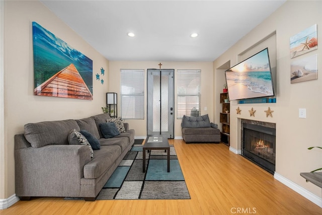 1879 Atlantic Ave Unit 15, Long Beach, CA 90806 - living area featuring wood finished floors, a fireplace, and recessed lighting