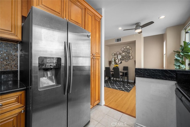 1879 Atlantic Ave Unit 15, Long Beach, CA 90806 - kitchen with appliances with stainless steel finishes, light tile patterned flooring, a ceiling fan, brown cabinets, and tasteful backsplash