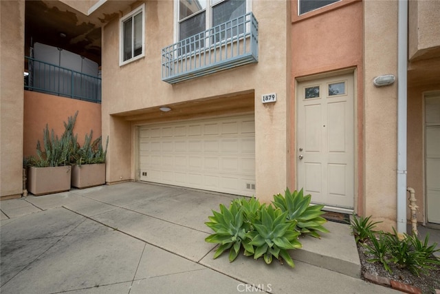 1879 Atlantic Ave Unit 15, Long Beach, CA 90806 - doorway to property featuring stucco siding and an attached garage