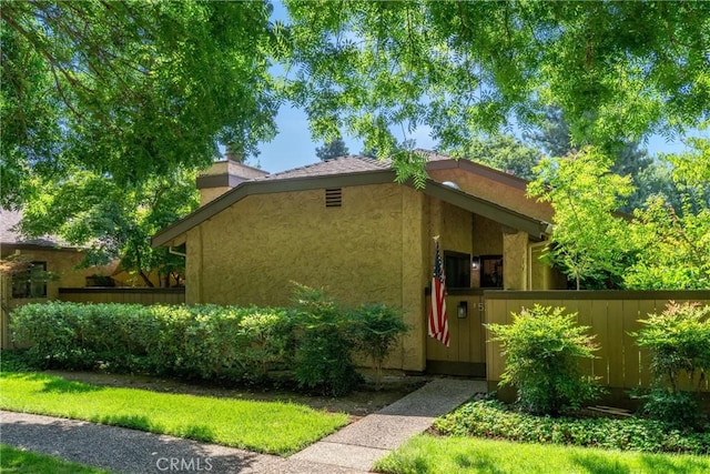 520 Wilshire Ct, Chico, CA 95973 - view of front of home with a chimney and stucco siding