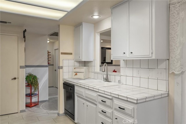 520 Wilshire Ct, Chico, CA 95973 - kitchen with black dishwasher, white cabinetry, decorative backsplash, tile countertops, and recessed lighting