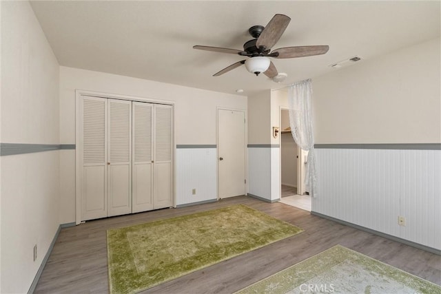 520 Wilshire Ct, Chico, CA 95973 - unfurnished bedroom with a wainscoted wall, wood finished floors, and a ceiling fan