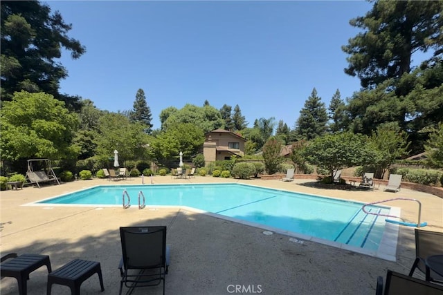 520 Wilshire Ct, Chico, CA 95973 - view of swimming pool with a patio and view of wooded area