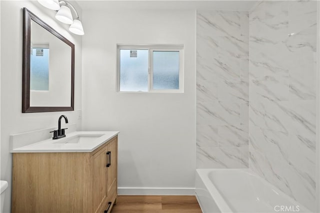 13612 Mercer St, Pacoima, CA 91331 - full bath with vanity, wood finished floors, and shower / bathtub combination
