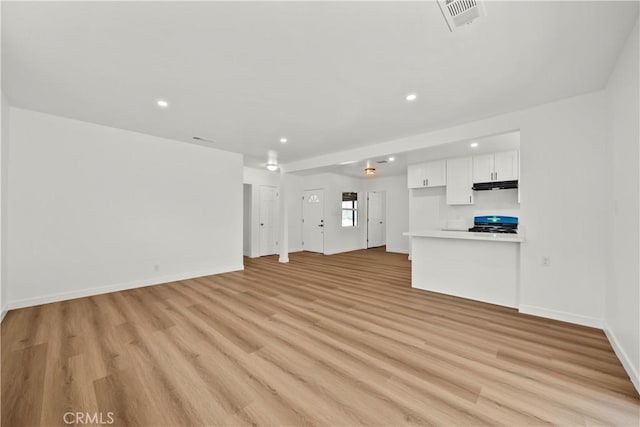 13612 Mercer St, Pacoima, CA 91331 - unfurnished living room with light wood-style floors and recessed lighting