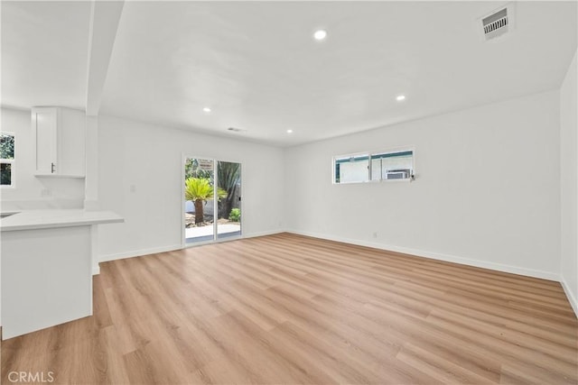 13612 Mercer St, Pacoima, CA 91331 - unfurnished living room featuring healthy amount of natural light, light wood-type flooring, and recessed lighting