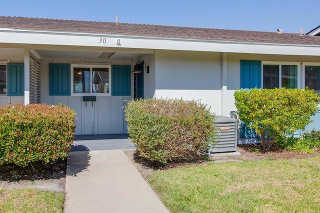 3755 N Vista Campana Unit 30, Oceanside, CA 92057 - doorway to property with board and batten siding, a shingled roof, a yard, and stucco siding