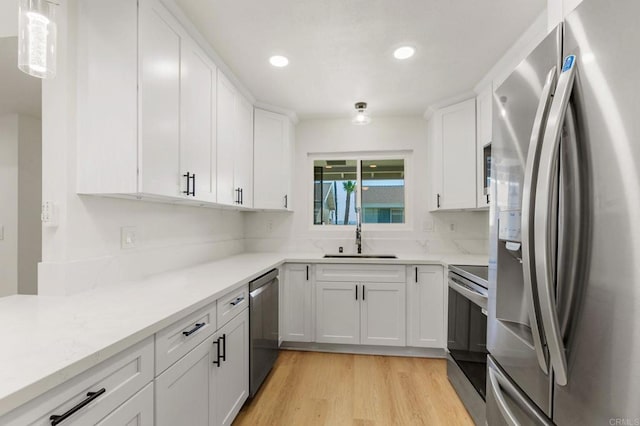 3755 N Vista Campana Unit 30, Oceanside, CA 92057 - kitchen featuring stainless steel appliances, light wood-type flooring, white cabinetry, recessed lighting, and backsplash
